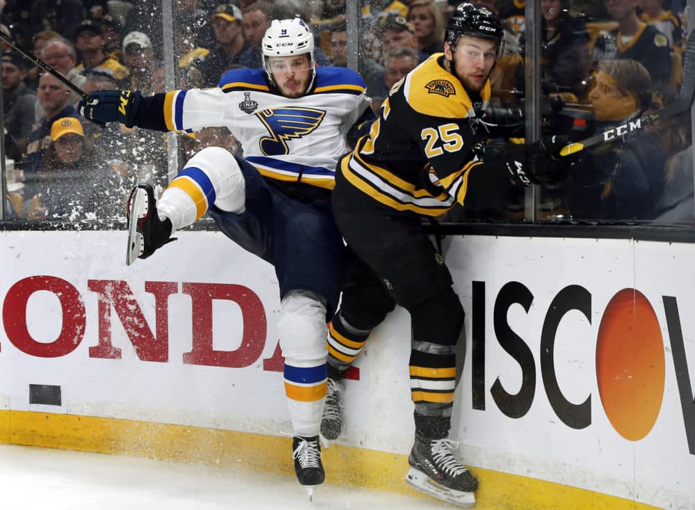 St. Louis Blues' Sammy Blais, left, and Boston Bruins' Brandon Carlo crash into the boards during the third period in Game 2 of the NHL hockey Stanley Cup Final, Wednesday, May 29, 2019, in Boston. (Michael Dwyer/AP)