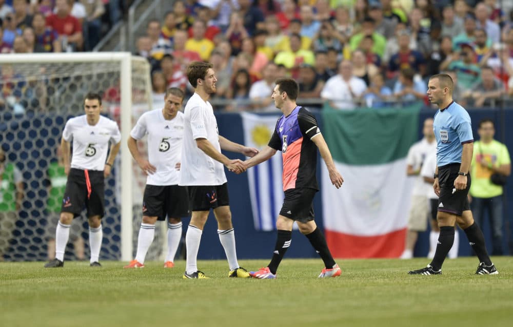 Matt Eliason shakes hands with Lionel Messi. (Brian Kersey/AP)