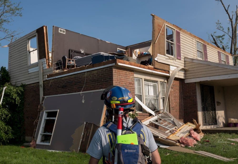 A member of search and rescue inspects a home in Trotwood, Ohio, on Tuesday after powerful tornadoes ripped through the U.S. state overnight, causing at least one fatality and widespread damage and power outages. (Seth Herald/AFP/Getty Images)
