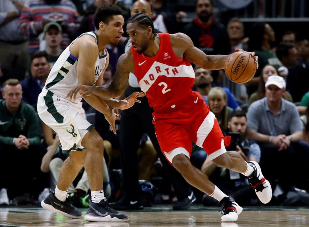 Kawhi Leonard dribbles the ball while being guarded by Malcolm Brogdon of the Milwaukee Bucks in the fourth quarter during Game Five of the Eastern Conference Finals of the 2019 NBA Playoffs. (Jonathan Daniel/Getty Images)