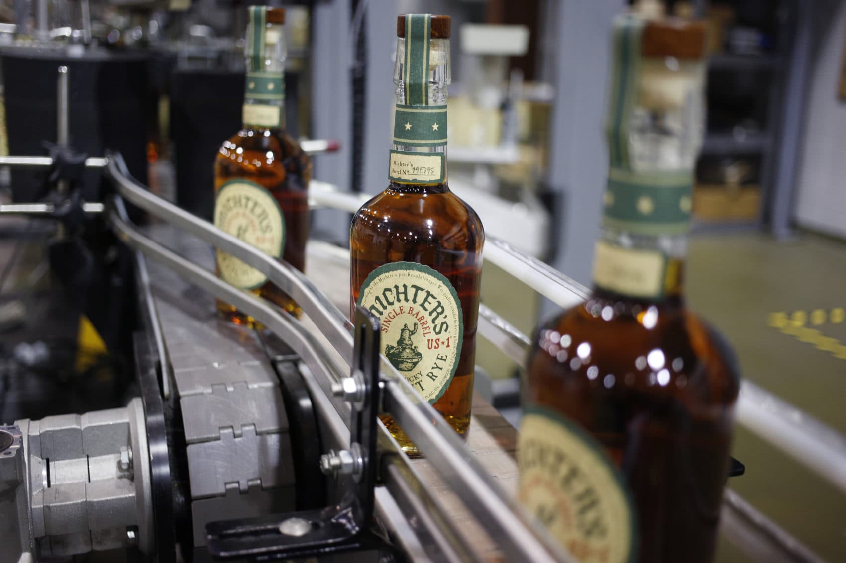 Bottles of Michter's Rye move down a conveyor belt at Michter's Shively Distillery in Louisville, Ky. (Luke Sharrett for Here & Now)