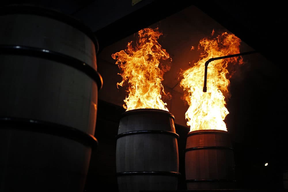 Flames rise from white oak bourbon barrels as they are charred at the Brown-Forman Cooperage in Louisville, Ky. (Luke Sharrett for Here &amp; Now)