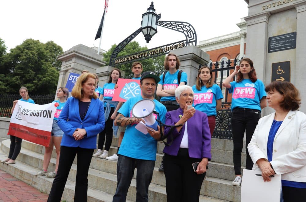 Sen. Patricia Jehlen (center), Rep. Tricia Farley-Bouvier (right), and U.S. Senate candidate Shannon Liss Riordan (left) rallied with activists in front of the State House on Tuesday in support of applying the standard minimum wage to tipped workers. (Sam Doran/SHNS)