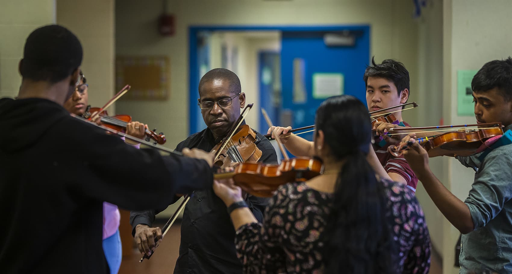 David France with members of his Roxbury Youth Orchestra (Jesse Costa/WBUR)
