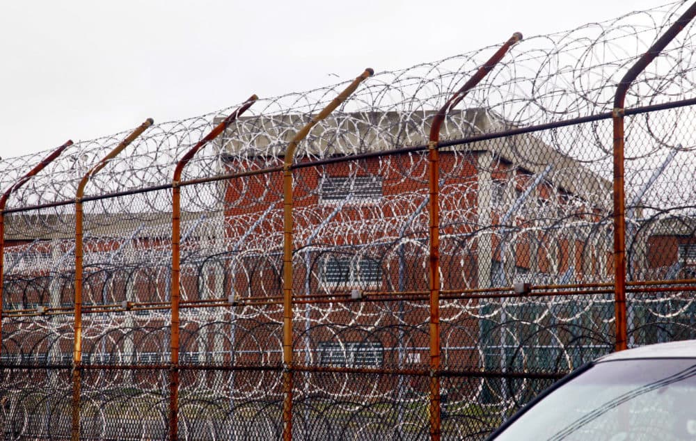 A security fence surrounds the inmate housing on New York's Rikers Island correctional facility. The state is poised to adopt new standards for solitary confinement in local jails at the urging of Democratic Gov. Andrew Cuomo. (Bebeto Matthews/AP)