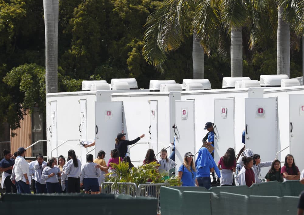 Migrant children stand outside portable restrooms at the Homestead Temporary Shelter for Unaccompanied Children, Monday, May 6, 2019, in Homestead, Fla. (Wilfredo Lee/AP)