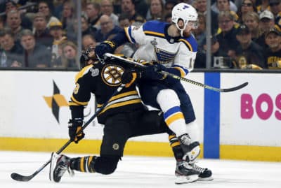 St. Louis Blues' Zach Sanford (12) checks Boston Bruins' David Pastrnak (88), of the Czech Republic, to the ice during the first period in Game 5 of the NHL hockey Stanley Cup Final, Thursday, June 6, 2019, in Boston. (Michael Dwyer/AP)