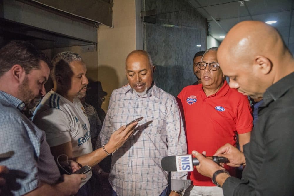 Leo Ortiz, center, father of David Ortiz, talks with journalists at the hospital where his son was hospitalized after being shot. (Ricardo Hernandez/AP)