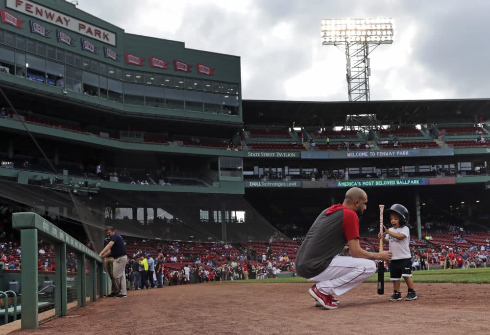 Boston Red Sox pitcher David Price plays with his son, Xavier before a game against the Texas Rangers at Fenway Park on Monday, June 10. (Charles Krupa/AP)