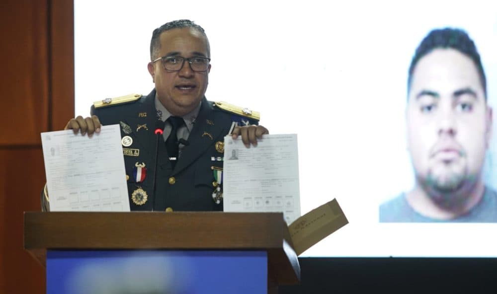 Earlier in June, the director of the National Police, Maj. Gen. Ney Aldrin Bautista Almonte, gives details on the attack on David Ortiz, in front of an image of Victor Hugo Gomez. According to Rodríguez, Ortiz was shot by a gunman who mistook him for the real target, Sixto David Fernández, and the attempted murder was ordered from the United States by Hugo Gomez, Fernández's cousin. (Roberto Guzman/AP)