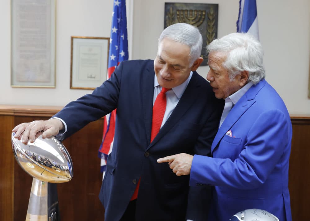 Israeli Prime Minister Benjamin Netanyahu holds the NFL Super Bowl trophy during a meeting with New England Patriots owner Robert Kraft in Jerusalem Thursday. Israel will honor Kraft with the 2019 Genesis Prize for his philanthropy and commitment to combating anti-Semitism. (Sebastian Scheiner/AP)