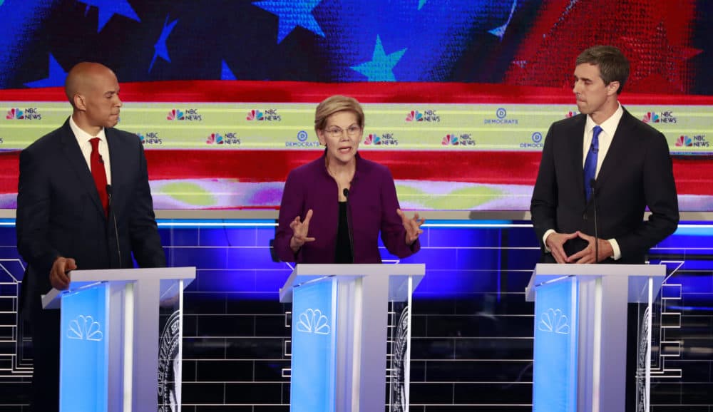 Democratic presidential candidate Sen. Elizabeth Warren answers a question as Sen. Cory Booker, D-N.J., and former Texas Rep. Beto O'Rourke, listen at the first presidential debate in Miami, on Wednesday evening. (Wilfredo Lee/AP)