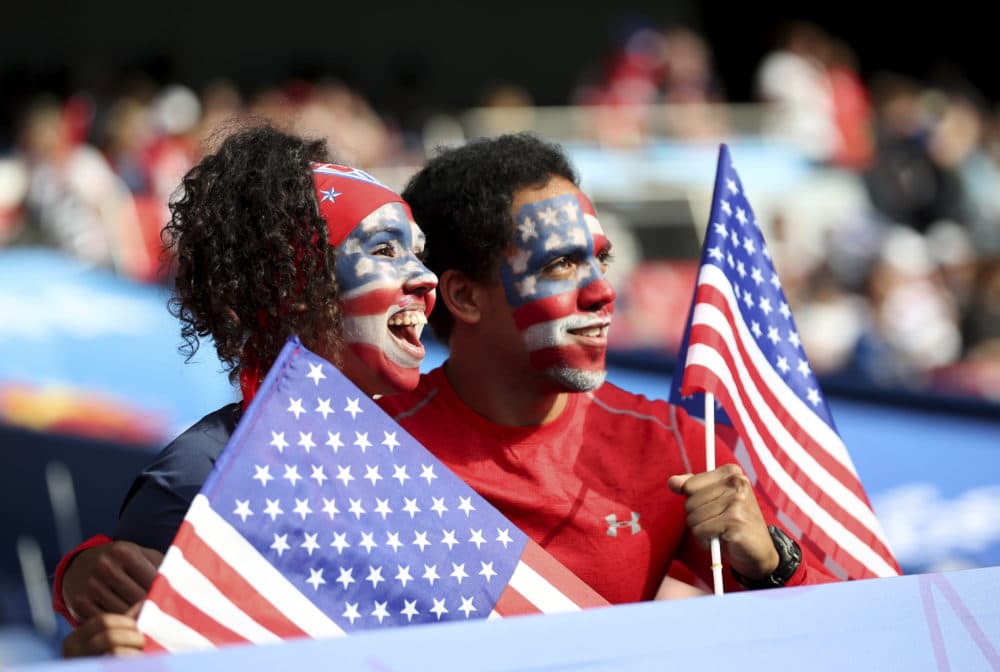 Fans for the U.S. hold U.S. flags and have painted faces prior to the Women's World Cup quarterfinal soccer match between France and the United States at the Parc des Princes, in Paris, Friday, June 28, 2019. (AP Photo/Francisco Seco)