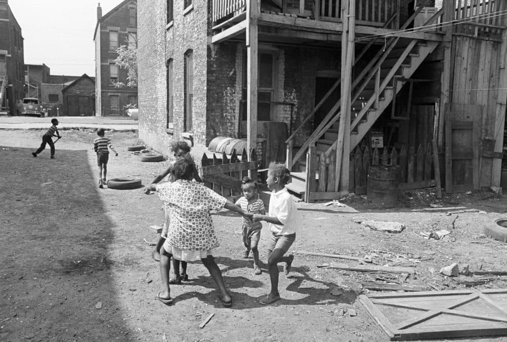 African-American children use a backyard in the slums of Chicago, Ill., as a playground, July 24, 1967. Most of the 324,000 people who live in this section of the West Side were black and poor. (Charles Knoblock/AP)