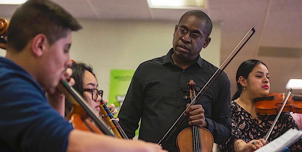 David France instructs members of his Roxbury Youth Orchestra. (Jesse Costa/WBUR)