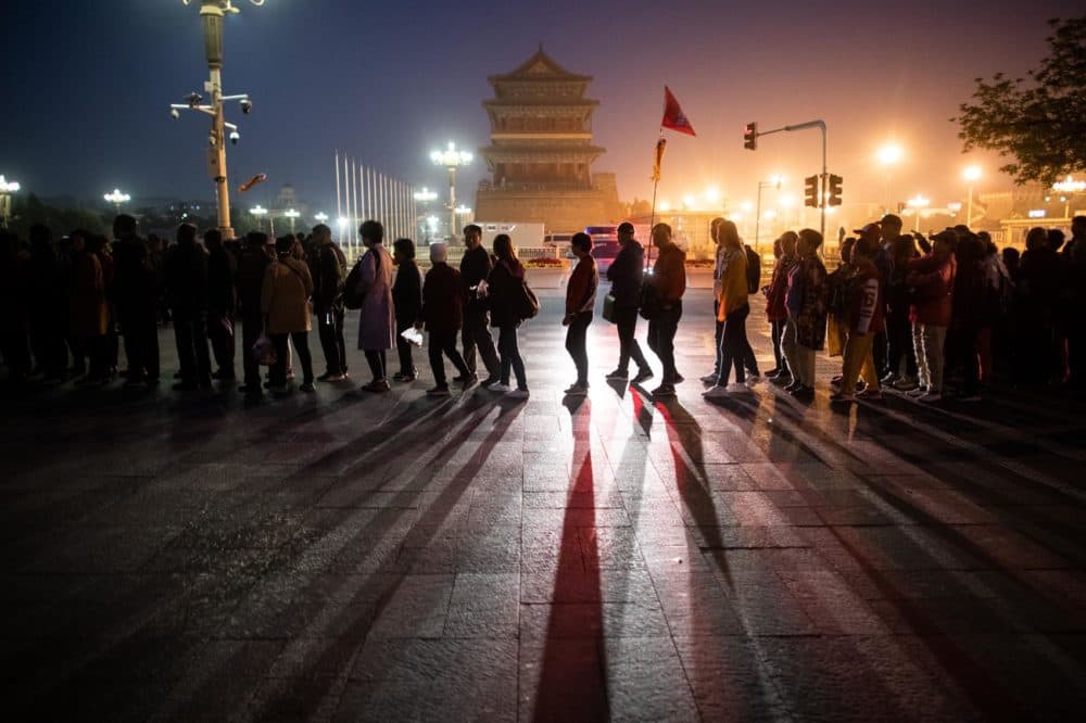 In this picture taken on April 10, 2019, tourists line up for the flag-raising ceremony at Tiananmen Square in Beijing. (STR/AFP/Getty Images)