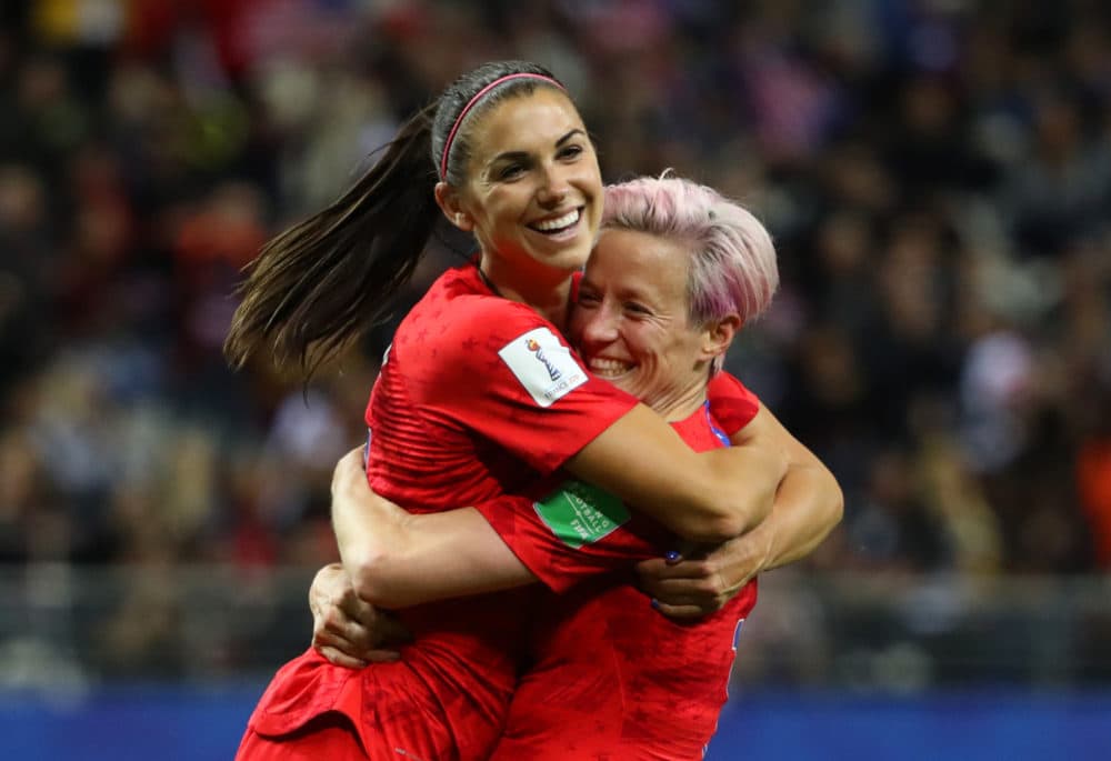 Alex Morgan celebrates with teammate Megan Rapinoe after scoring her fifth goal in Team USA's blowout win against Thailand. (Robert Cianflone/Getty Images)