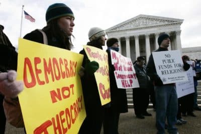 Activists hold posters during a rally in front of the U.S. Supreme Court to support separation of church and state, March 2, 2005, in Washington, D.C. (Alex Wong/Getty Images)