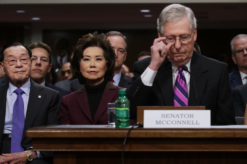Elaine Chao (center) listens to her husband Senate Majority Leader Mitch McConnell, R-Ky., during her confirmation hearing to be the next U.S. secretary of transportation, Jan. 11, 2017. (Chip Somodevilla/Getty Images)