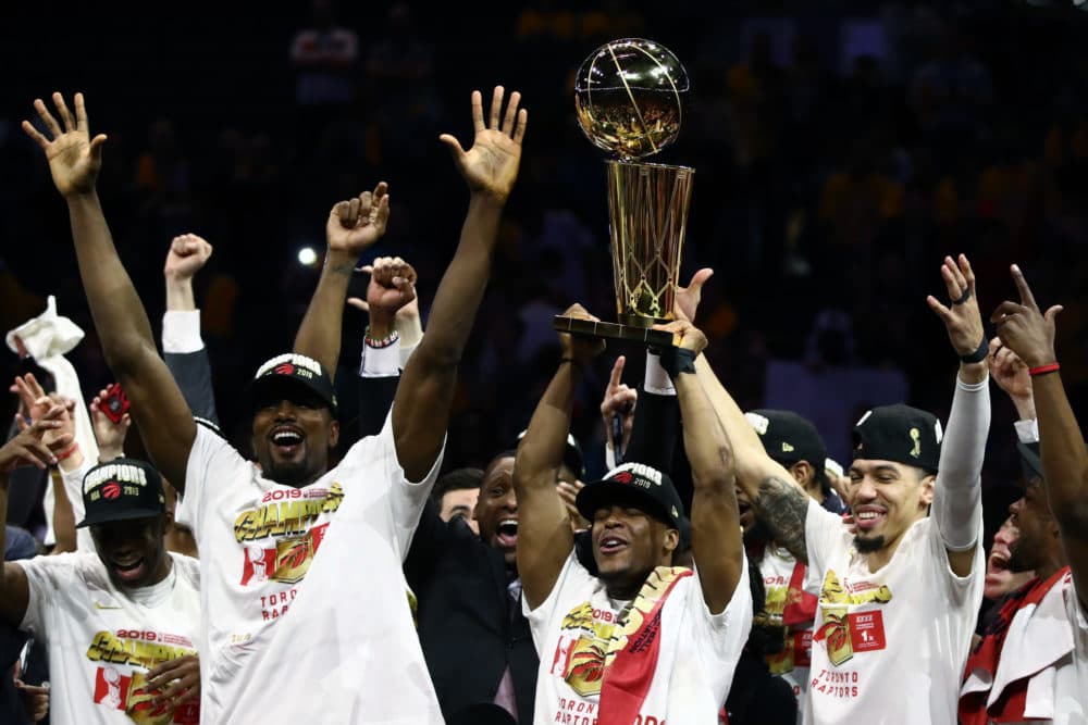The Toronto Raptors celebrate with the Larry O'Brien Trophy. (Ezra Shaw/Getty Images)
