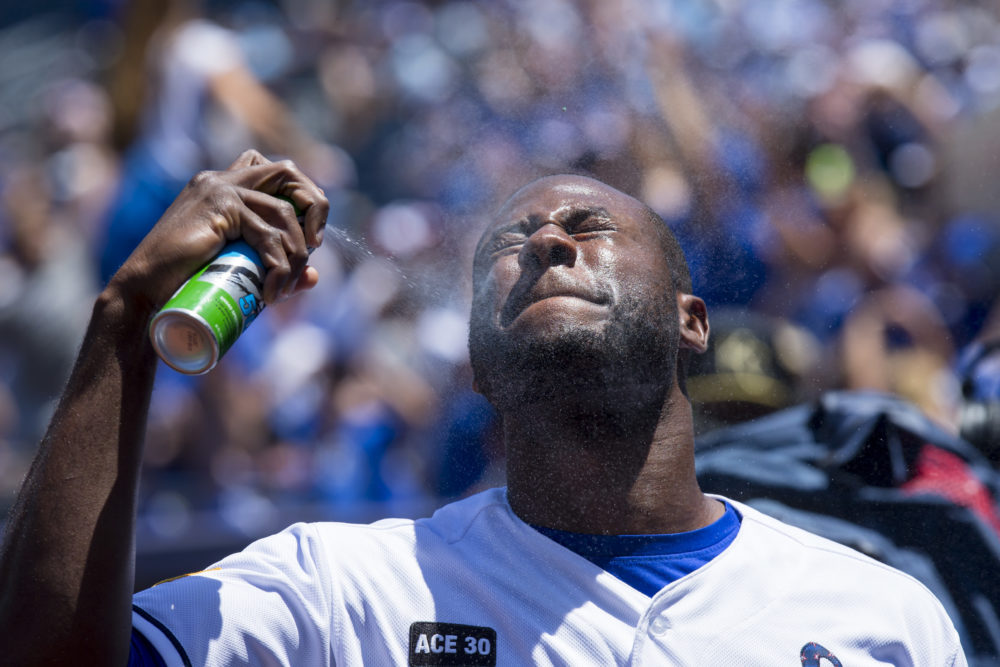 The ingredients in chemical sunscreen enter the bloodstream after just one day of use, according to a new study conducted by the Food and Drug Administration. Pictured: Lorenzo Cain of the Kansas City Royals sprays sunblock on his face before a Major League Baseball game in 2017. (Kyle Rivas/Getty Images)