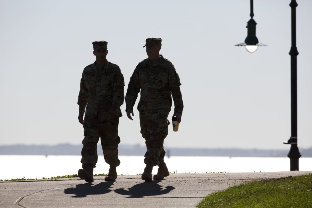 Two soldiers from the 1st 101st Field Artillery of the Massachusetts National Guard walk at Castle Island in Boston in 2017. (Michael Dwyer/AP)