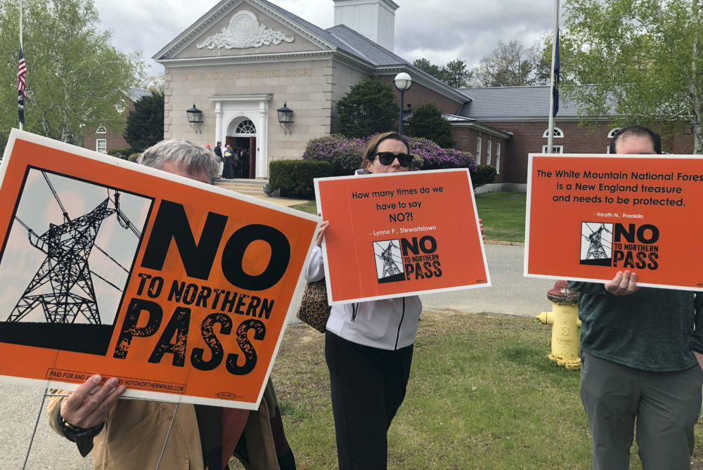 Opponents of the proposed Northern Pass power project protest outside the New Hampshire Supreme Court on May 15 in Concord, N.H. (Michael Casey/AP)