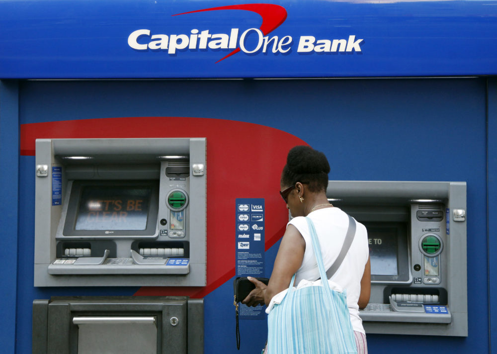 In this July 18, 2013, file photo, a woman uses a Capital One Bank automated teller machine in New York. (Mark Lennihan/AP)