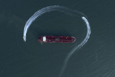 In this Sunday, July 21, 2019 photo, an aerial view shows a speedboat of Iran's Revolutionary Guard moving around the British-flagged oil tanker Stena Impero which was seized in the Strait of Hormuz on Friday by the Guard. (Morteza Akhoondi/Tasnim News Agency via AP)