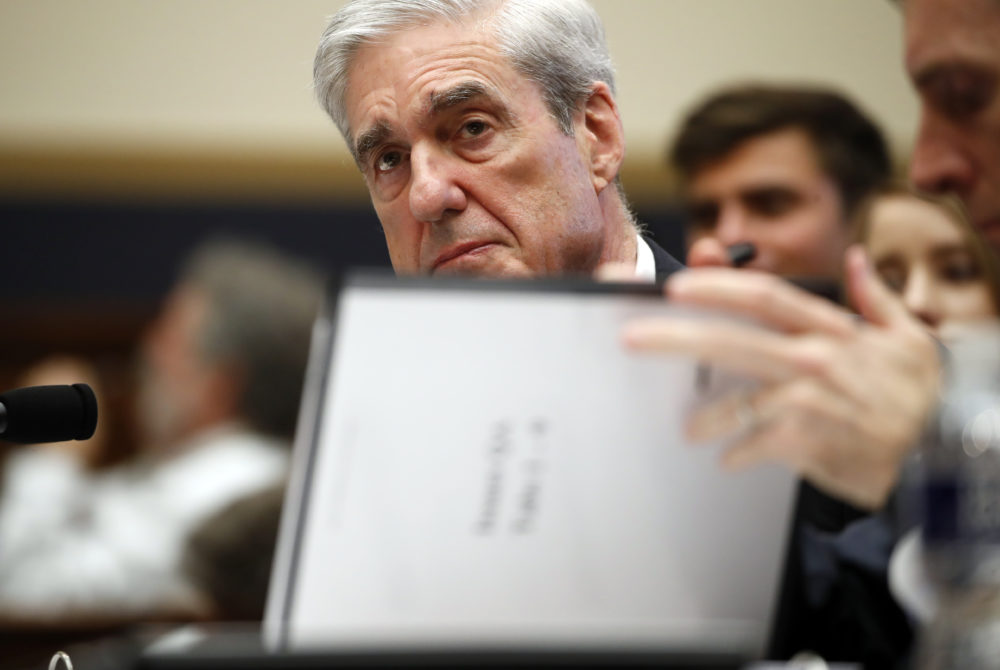 Former special counsel Robert Mueller checks pages in the report as he testifies before the House Judiciary Committee on Wednesday, July 24, 2019 in Washington. (Alex Brandon/AP)