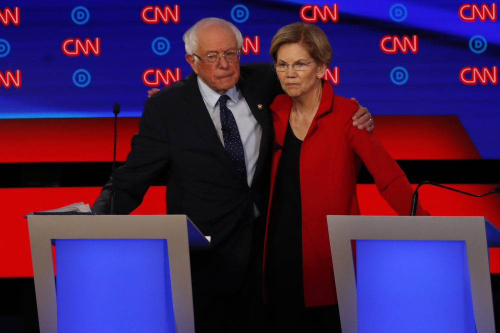 Sen. Bernie Sanders, I-Vt., and Sen. Elizabeth Warren, D-Mass., embrace after the first of two Democratic presidential primary debates hosted by CNN on July 30 in Detroit. (Paul Sancya/AP)