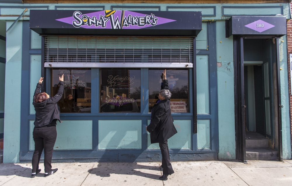 In this file photo, Mia McIlvany and Andrea Walker open the doors of Sonny Walker's in Roxbury for business. (Jesse Costa/WBUR)