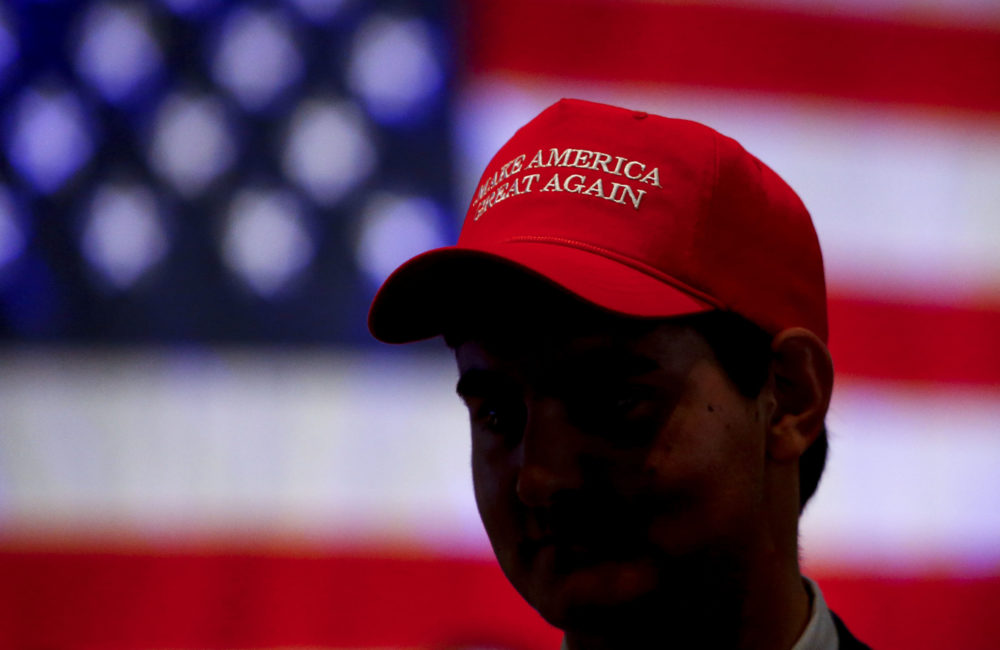 Oliver Lester, of Montgomery, Ala., wears a hat with President Trump's campaign slogan as he watches results come in for Gov. Kay Ivey at a watch party on Nov. 6, 2018, in Montgomery. (Butch Dill/AP)