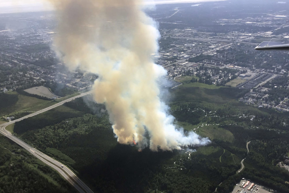In this photo taken Tuesday, July 2, 2019, and provided by the Alaska Division of Forestry, smoke rises from a wildfire in east Anchorage, Alaska. (Jason Jordet/Alaska Division of Forestry via AP)