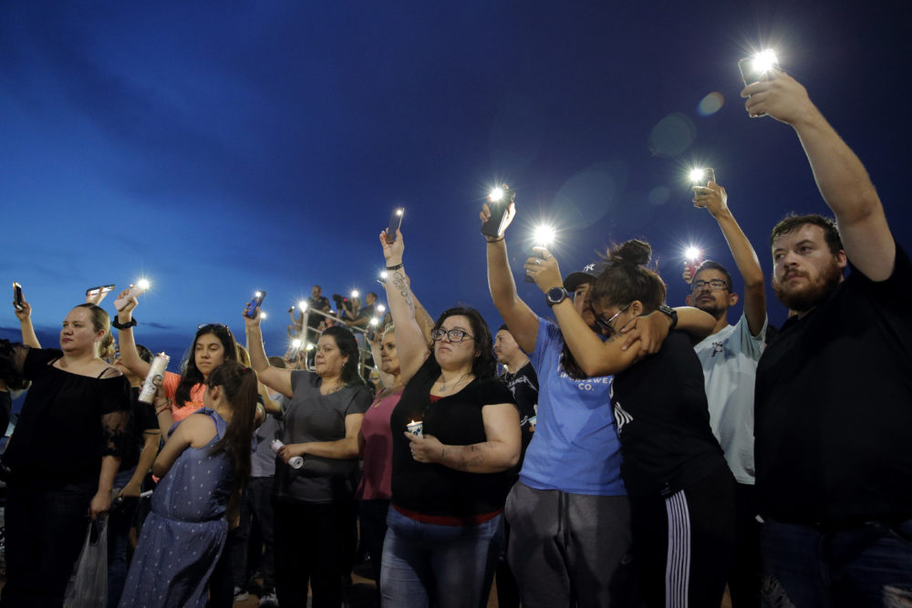 People on Sunday attend a vigil for victims of Saturday's mass shooting at a shopping complex in El Paso, Texas. (John Locher/AP)