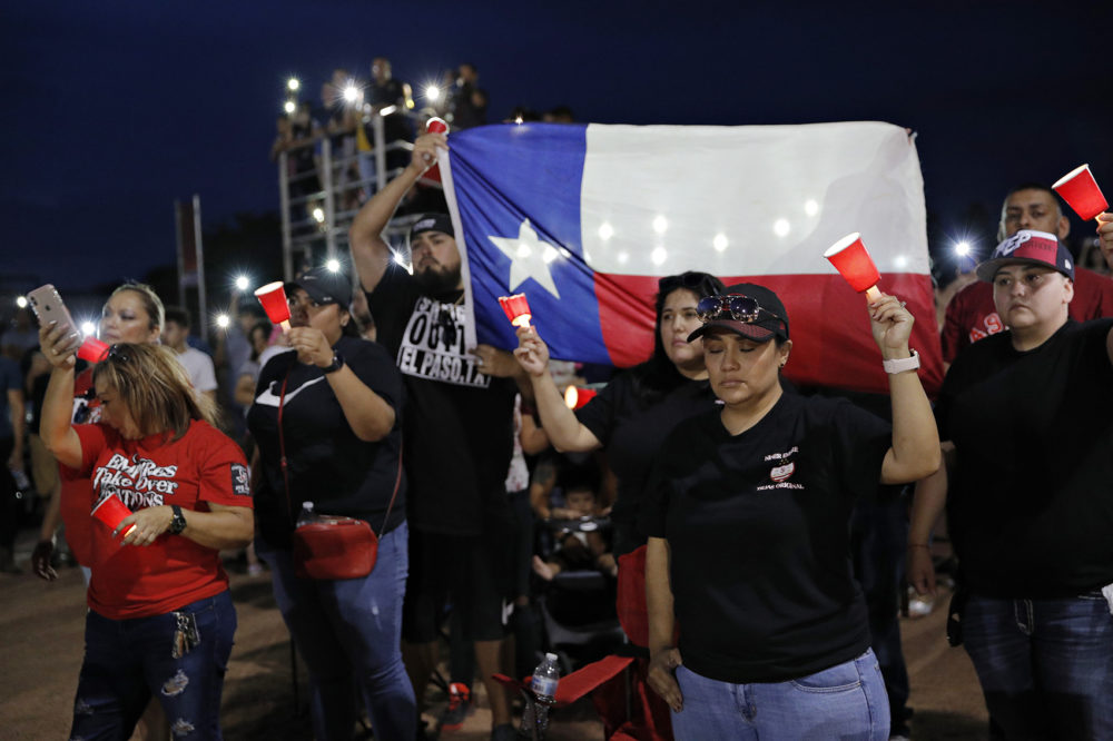 People attend a vigil for victims of Saturday's mass shooting at a shopping complex Sunday, Aug. 4, 2019, in El Paso, Texas. (John Locher/AP)
