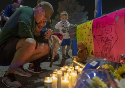 Rene Aguilar and Jackie Flores pray at a makeshift memorial for the victims of Saturday's mass shooting at a shopping complex in El Paso, Texas, Sunday, Aug. 4, 2019. (Andres Leighton/AP)