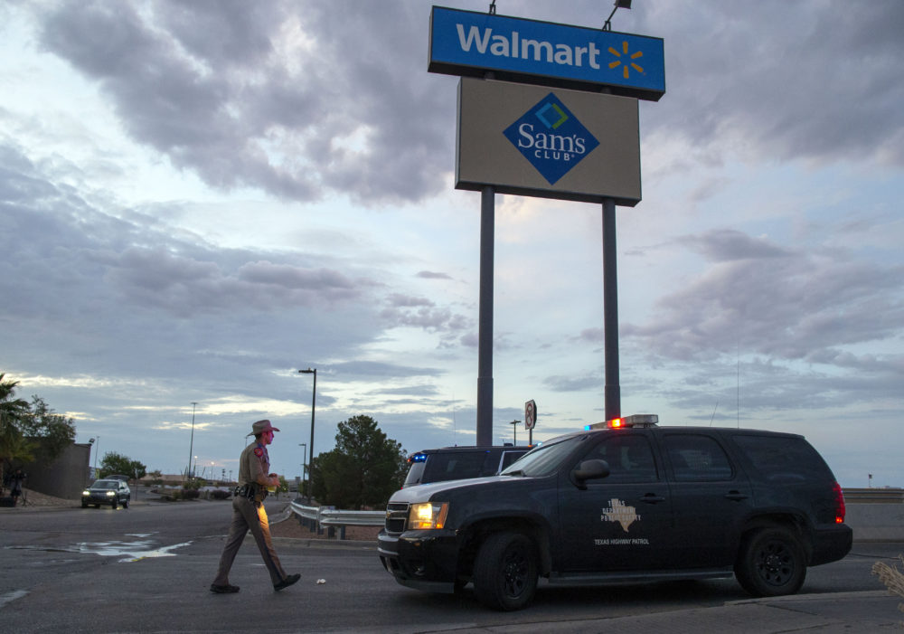 A Texas State Trooper walks back to his car while providing security outside the Walmart store in the aftermath of a mass shooting in El Paso, Texas. (Andres Leighton/AP File Photo)