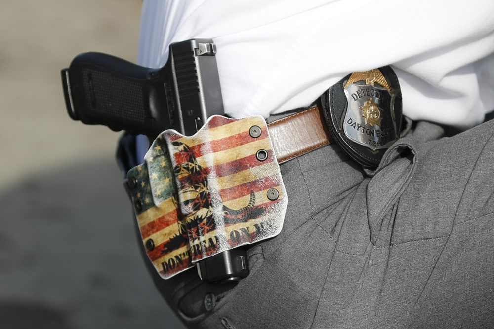 A Dayton Police detective wears his sidearm in a holster on Aug. 6 in Dayton. (John Minchillo/AP)