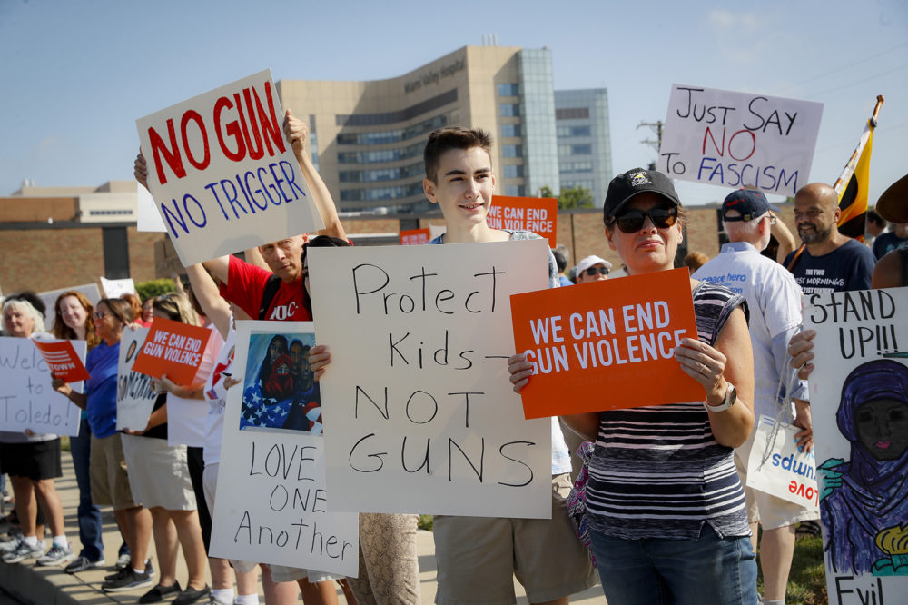 Demonstrators gather to protest the arrival of President Donald Trump outside Miami Valley Hospital after a mass shooting that occurred in the Oregon District early Sunday morning, Wednesday, Aug. 7, 2019, in Dayton. (John Minchillo/AP)
