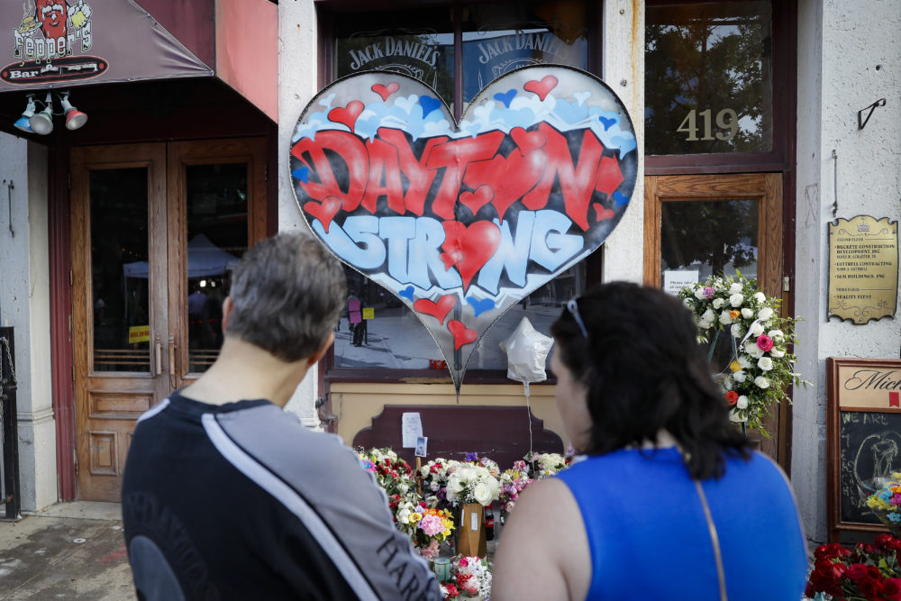 Mourners last week visit a makeshift memorial for the slain and injured victims of a mass shooting that occurred in the Oregon District in Dayton, Ohio. (John Minchillo/AP)
