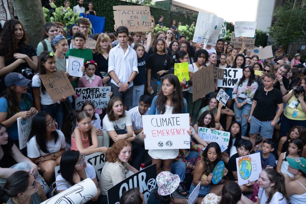 Climate justice activist Xiye Bastida (middle, holding the white &quot;Climate Emergency&quot; sign) strikes outside the U.N. headquarters with Swedish environmental activist Greta Thunberg. Hundreds of other teenagers protested outside the U.N. in New York City. (Bryan R. Smith/AFP/Getty Images)