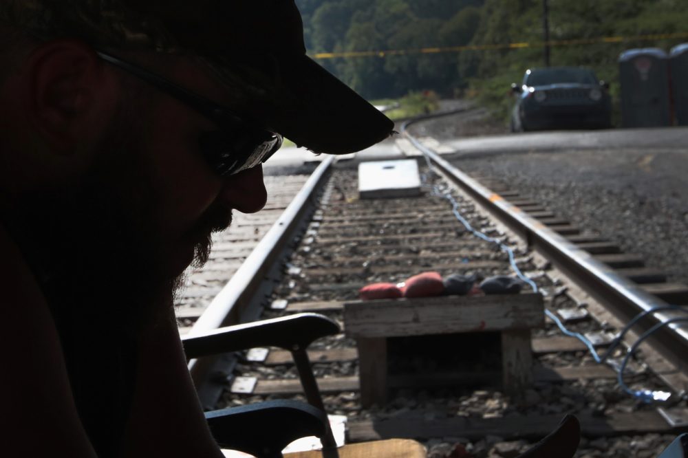 Chris Rowe, an unemployed Blackjewel coal miner, mans a blockade of the railroad tracks that lead to the mine where he once worked on August 24, 2019 in Cumberland, Kentucky. (Scott Olson/Getty Images)