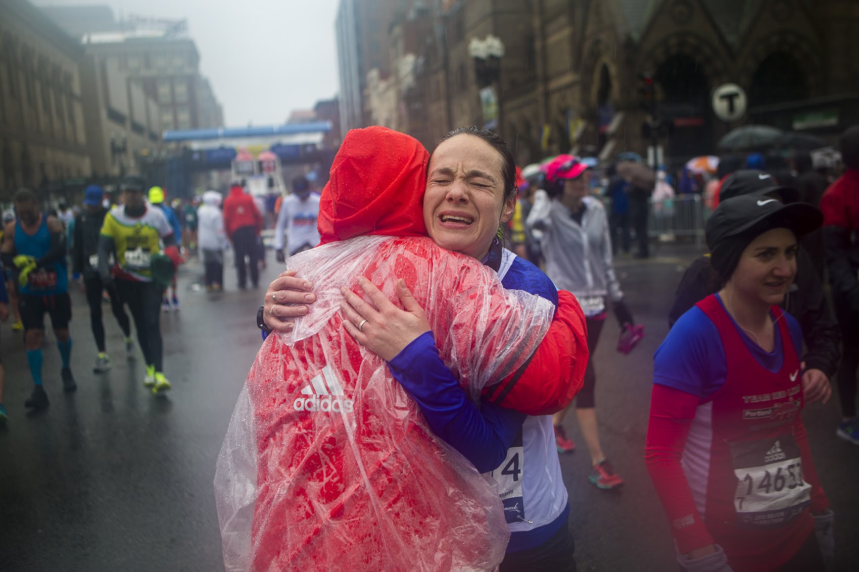 Alexandra Barak of Isreal gets a congradulatory hug from Boston Marathon volunteer Angela Coulombe after finishing. (Jesse Costa/WBUR)