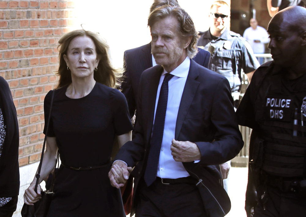 Felicity Huffman arrives at federal court with her husband William H. Macy for sentencing in a nationwide college admissions bribery scandal on Sept. 13 in Boston. (Elise Amendola/AP)