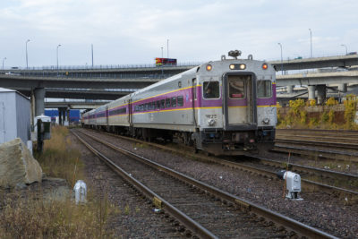 A MBTA commuter rail train rolls slowly toward North Station in Cambridge. (Jesse Costa/WBUR)