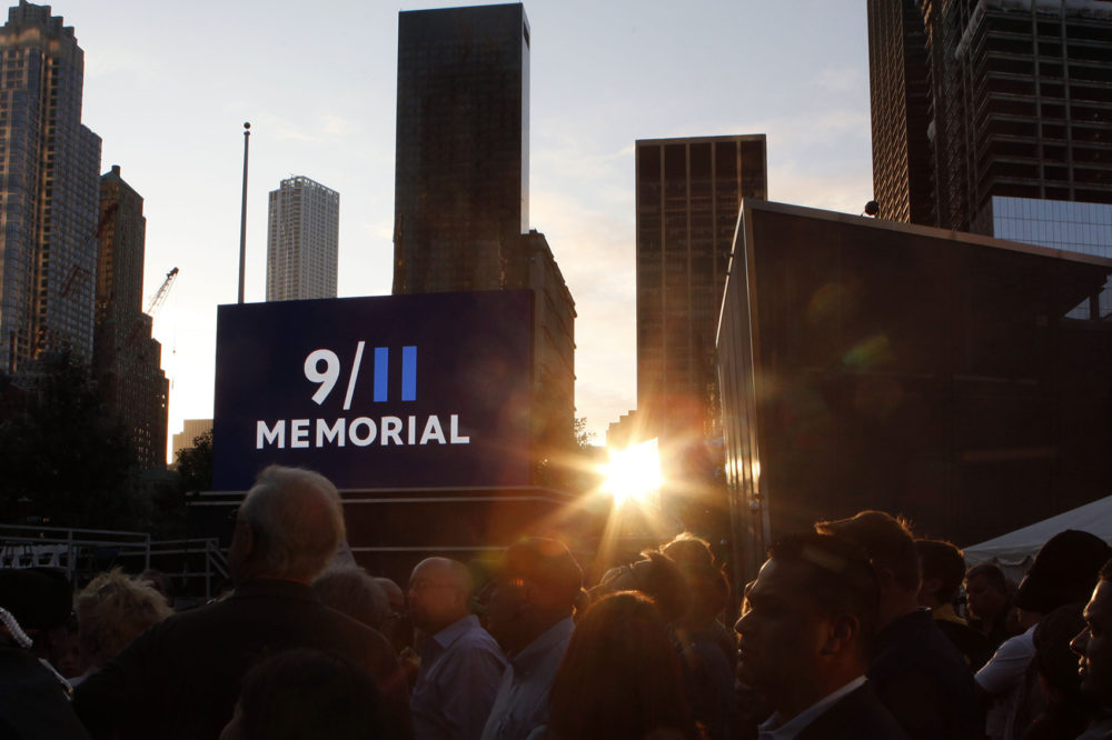 Friends and relatives of the victims of 9/11 gather for a ceremony marking the 10th anniversary of the attacks at the National September 11 Memorial at the World Trade Center site, Sunday, Sept. 11, 2011, in New York. (Jason DeCrow/AP)