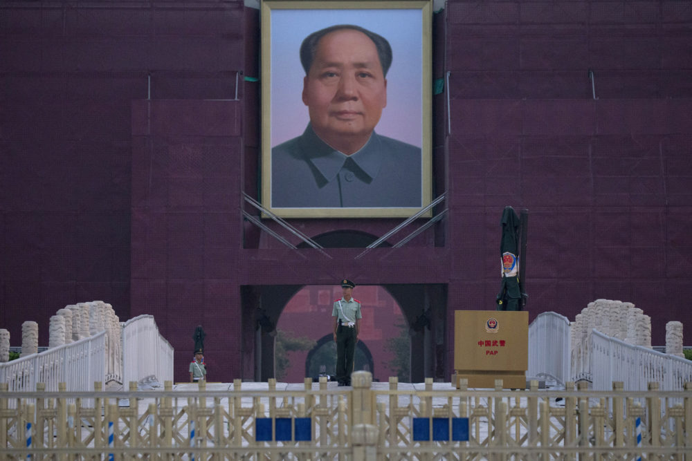 A Chinese paramilitary policeman stands guard in front of Mao Zedong's portrait on Tuesday, June 4, 2019. (Ng Han Guan/AP)