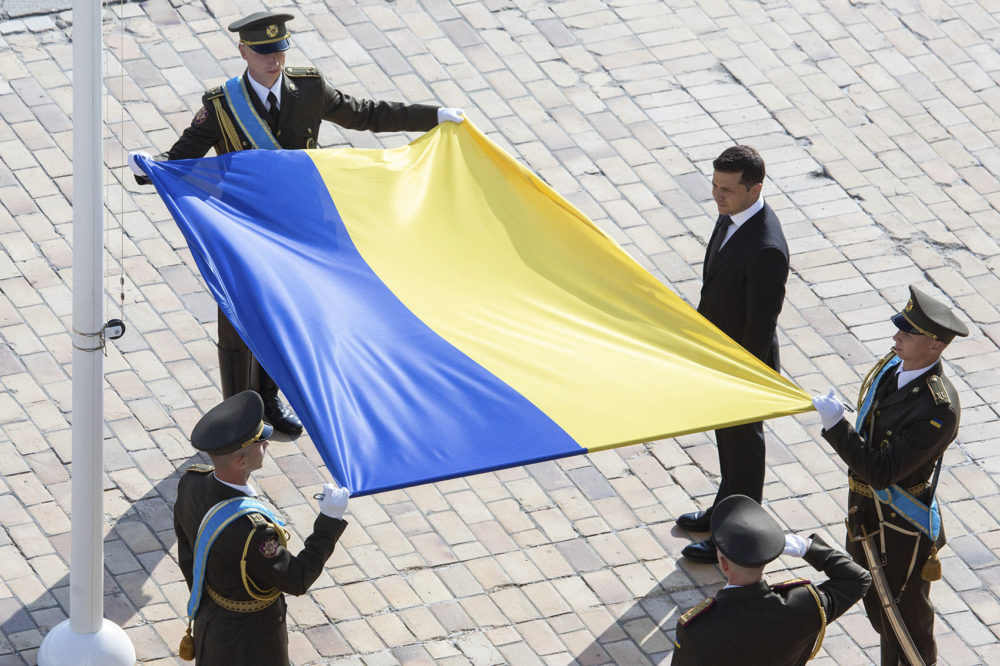Ukrainian President Volodymyr Zelenskiy, right, attends a ceremony during the National Flag Day celebration at the St. Sophia square in downtown Kyiv, Ukraine, Friday, Aug. 23, 2019. (Ukrainian Presidential Press Office via AP)