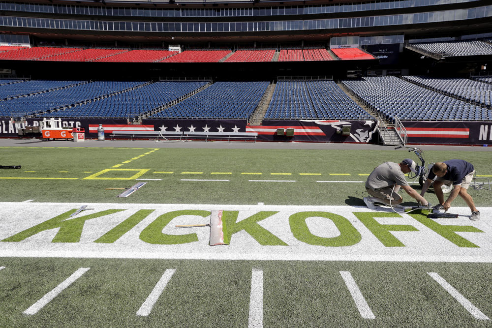 Grounds crew paint finishing touches on &quot;Kickoff&quot; on the field at Gillette Stadium, Sept. 4, 2019, in Foxborough, Mass. (Steven Senne/AP)